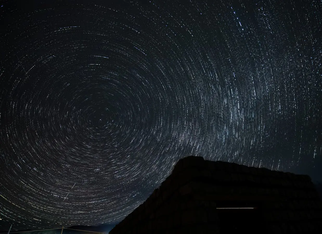 Star trails above a high ridge